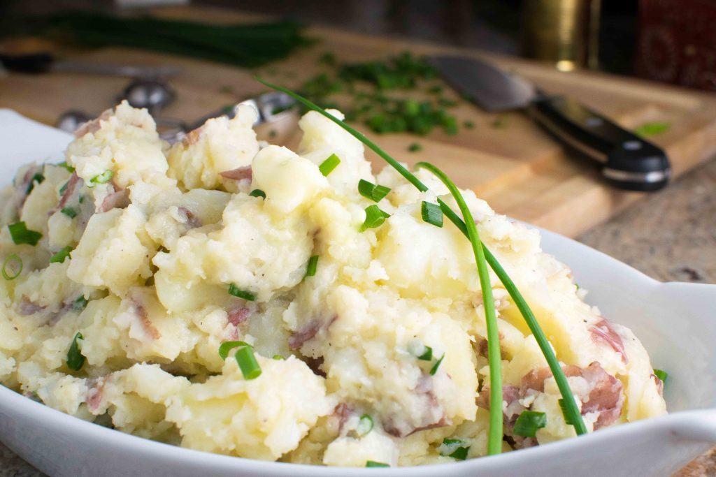 rustic mashed potatoes are made with a potato masher and a lot of butter